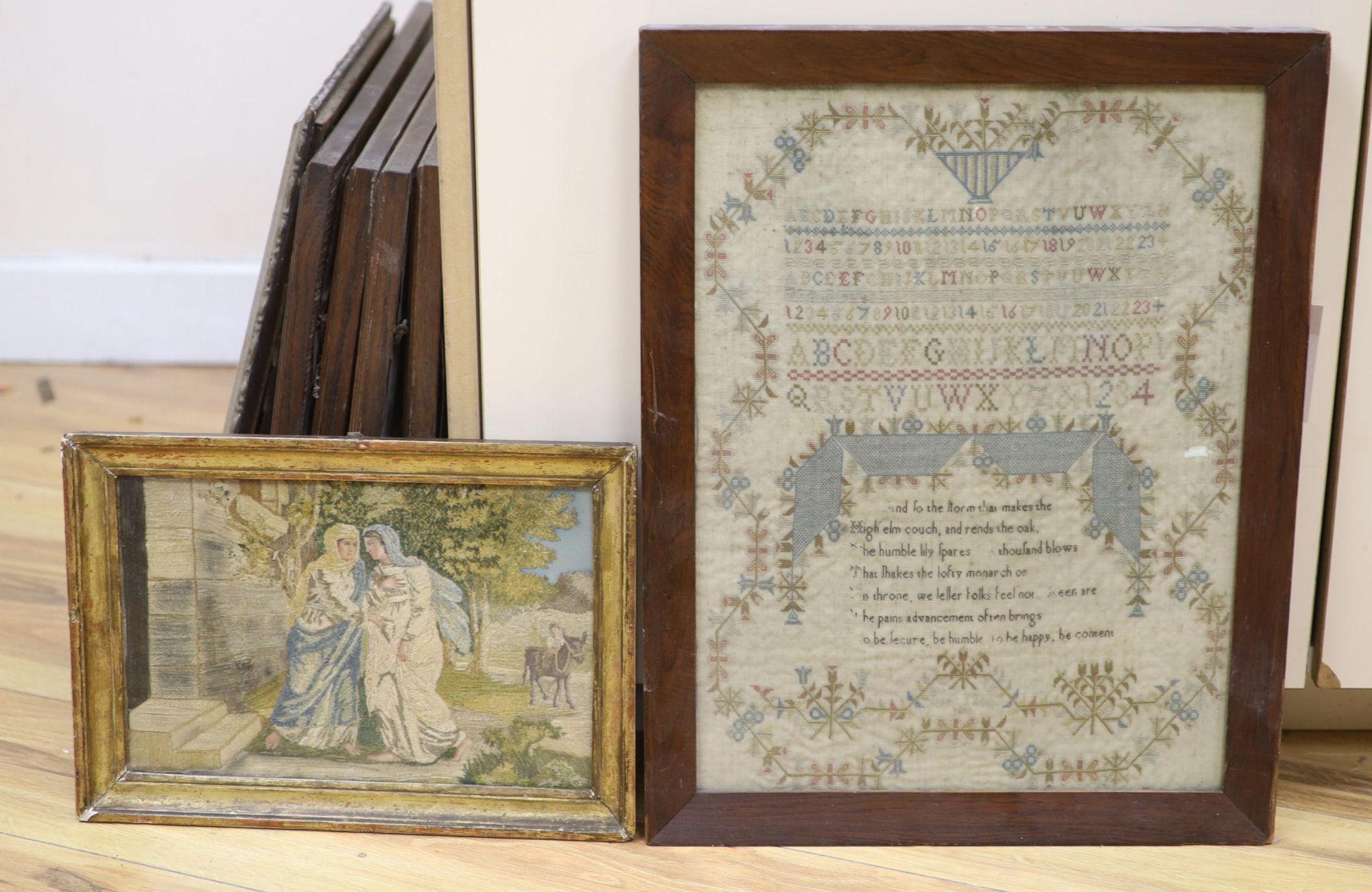 A 19th century sampler, in rosewood frame, together with a Regency silkwork, framed, largest overall 48 x 38cm